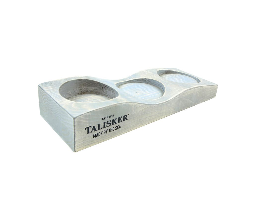 Rustic washed wooden POS block with three circular recesses and Talisker branding on the side.