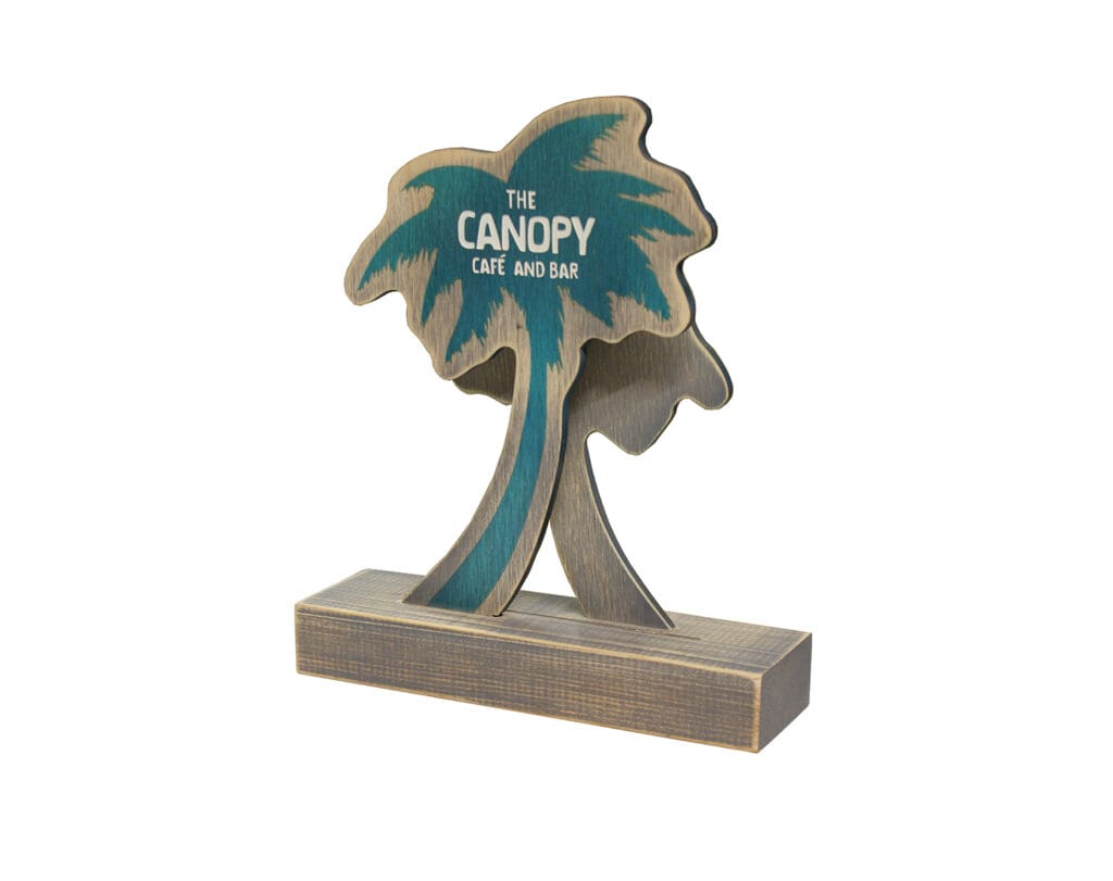 The Canopy Café and Bar shaped wooden menu holder with printed palm tree branding in a freestanding base