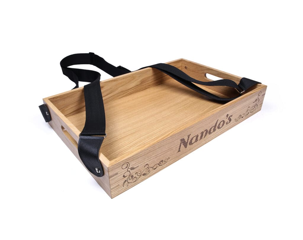 Oak serving tray with Nando’s branding and black carry strap