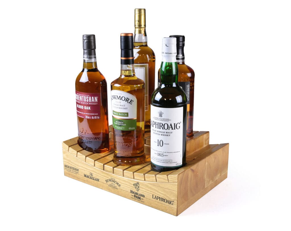 Tiered wooden bottle display stand holding multiple whisky bottles for bar back merchandising and premium spirit promotion.