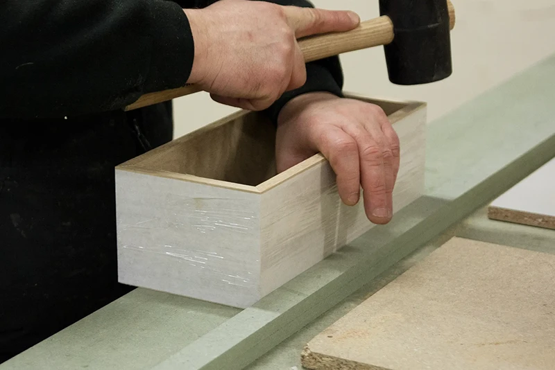 Morans Wood employee making a prototype wooden box