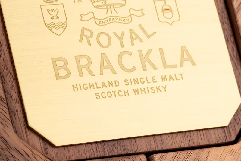Close up or wooden box and engraved metal plate to finish